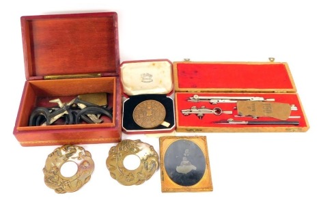 A group of collectables, comprising a leather bound wooden box containing lead letters, brass and steel cheroot cutter, City and Guilds of London Institute Department of Technology Examination bronze medal, named to Brian Derrick Trafford, First Prize, Fa