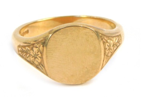 A 9ct gold signet ring, with oval shield, with engraved floral design shoulders, size Z+1½, 11g.