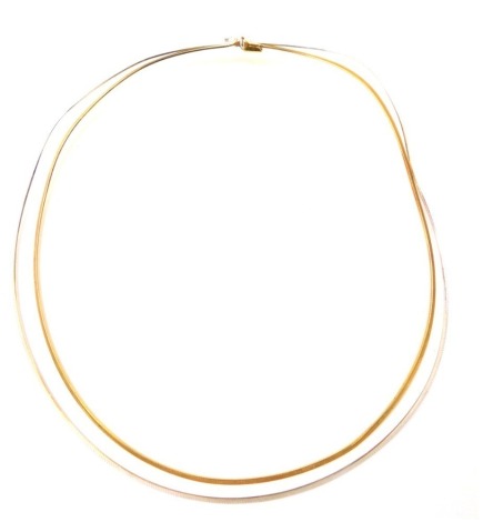 A 9ct gold two strand necklace, with gold and silver briquette band, with clip and clasp, 30cm long, 13.2g all in.