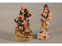 A 19thC Staffordshire pottery figure group modelled as a boy climbing a