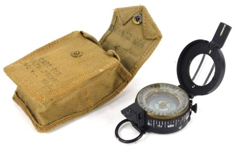 A World War II military compass, Mark III 1942, by TG and Company Limited London, number 3183017, with a canvas pouch.