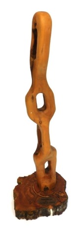 A modernist olivewood sculpture, raised on a bog oak base, bears oval plaque, 81cm high.