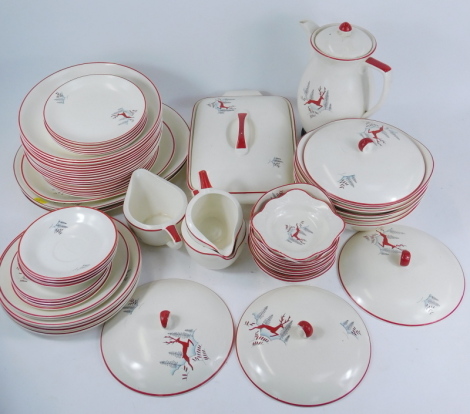 A Crown Devon Fielding's Leaping Deer pattern pottery part dinner service, decorated in the Winter Scene with red stag, comprising coffee pot on stand, three sauce boat and cream jugs, tureen and cover, meat plate, four tureens and lid, two spoon dishes, 