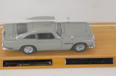 A Danbury Mint 1:25 scale model of the 1964 James Bond 007 Aston Martin DB5, serial number B4604, oak stand and Perspex cover, 29cm wide overall, and two certificates of authenticity, numbers B4604 and B4125. - 2