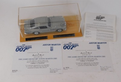 A Danbury Mint 1:25 scale model of the 1964 James Bond 007 Aston Martin DB5, serial number B4604, oak stand and Perspex cover, 29cm wide overall, and two certificates of authenticity, numbers B4604 and B4125. - 3