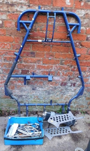 A Go-Kart chassis, exhaust part and various pipes and parts. (a quantity)