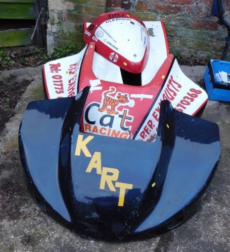 Three go kart hoods, comprising a black kart, a Cat Racing Raider Kart, and a DDJ motor bike cover. (3)