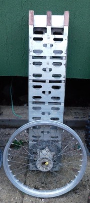 A motorcycle ramp and a wheel spoke. (2)