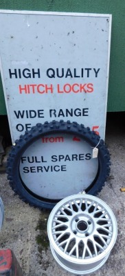 A Motor Service advertising sign, tube tyre and a Ford alloy. (3)