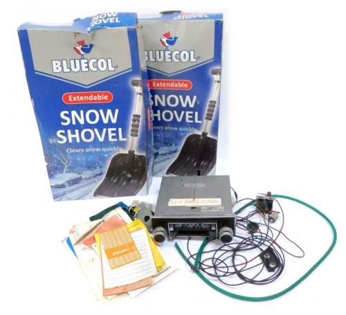 Two Bluecol extendable snow shovels, and a car radio. (3)