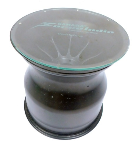 A Sahara Orceindia Formula 1 Team F1 alloy side table, with circular glass top, on an 88S RE1533 alloy, 37cm high, 35cm diameter.