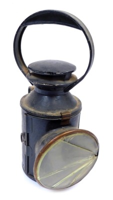 A railway inspection lantern, with black metal casing, with a circular glass dial, 30cm high.