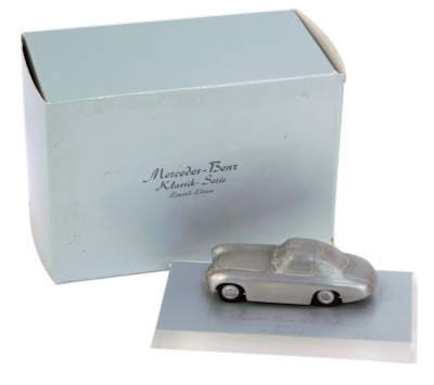 A Mercedes Benz 300SL 1952 diecast model, on perspex plinth, 15cm wide, boxed.