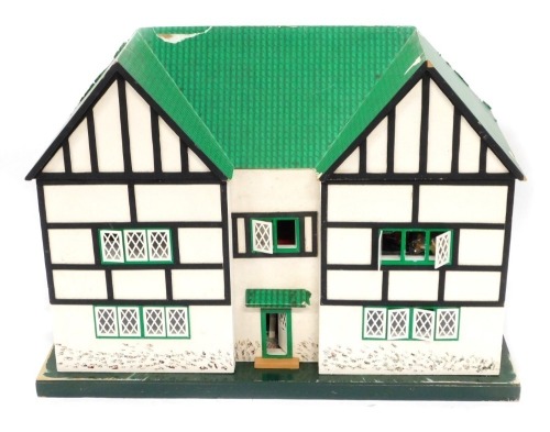 A mock Tudor doll's house, including furniture.