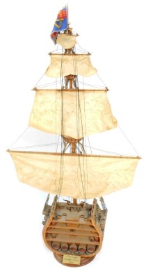 A wooden ships model, to show the interior section of a ship, with three tiered mast, on circular wooden base, 86cm high, 44cm wide.