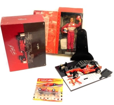 A Hot Wheels Racing Michael Schumacher Collection 248 F1 diecast car and figure, a Michael Schumacher limited edition collectors figure, and a Shell V Power F2005 F1 car. (3)