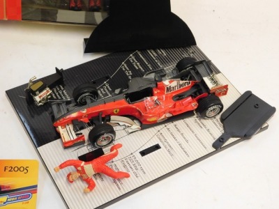 A Hot Wheels Racing Michael Schumacher Collection 248 F1 diecast car and figure, a Michael Schumacher limited edition collectors figure, and a Shell V Power F2005 F1 car. (3) - 2