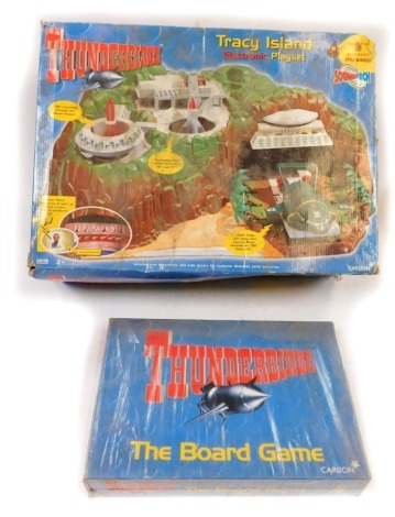 A Vivid Imaginations Thuderbird Tracey Island electronic play set and Thunderbirds the board game, boxed. (2)