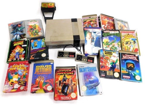 A Nintendo Entertainment system NS version, with controllers, game genie and boxed games including Konami Snakes Revenge, Balderdash, Konami Silence Service, Techno Shadow Warriors Ninja Gaiden, Tyto Blue Shadow, Nintendo Entertainment Gum Cho, Terminator