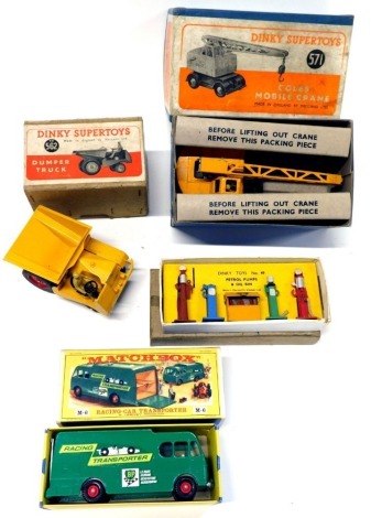 Dinky and Matchbox diecast, comprising a M6 Racing car transporter, boxed, 562 Dinky Super Toys dumper truck, Dinky Super Toys 571 Carl's mobile crane, and Dinky Toys number 49 petrol pumps and oil bin, boxed. (4)