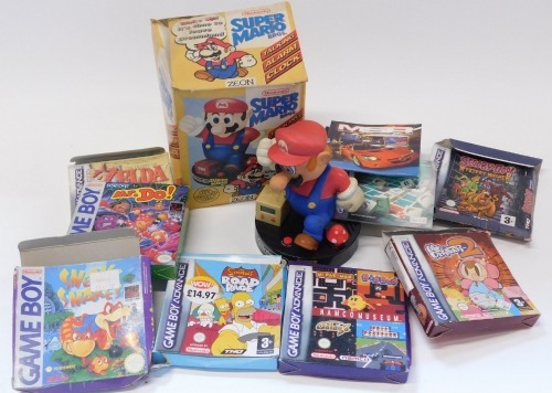 A Nintendo Gameboy and Gameboy Advanced vacant game boxes, including Mr Driller 2, Mr Do, The Legends of Zelda Four Swords, Sneaky Snakes, and a Nintendo Super Mario Brothers talking alarm clock by Zion.