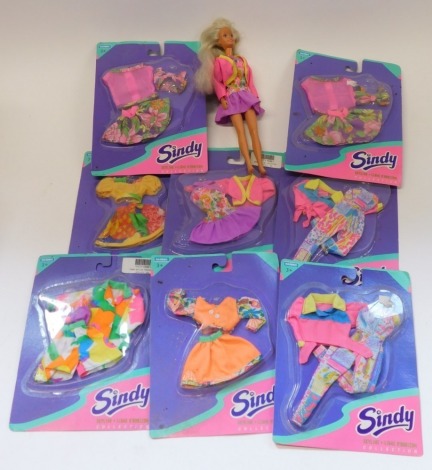 A group of Sindy clothing, each in a blister pack, and a Hasbro Sindy Skyline Collection figure. (1 box)