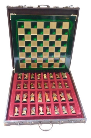 A Manopoulos resin chess board, with medieval figures, in fitted wooden carry case.