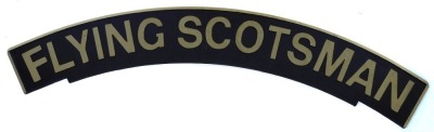 An arched railway engine sign The Flying Scotsman, on wooden backing, painted on black ground with gold lettering, 113cm wide.