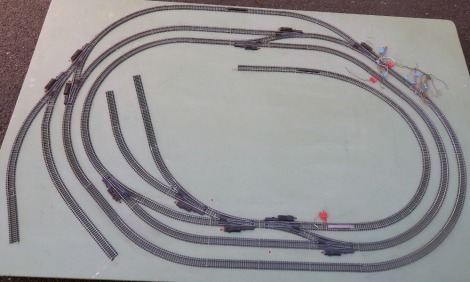 An OO gauge model railway layout, the base with four legs, 125cm high, 183cm wide.