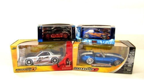 Jada and other diecast cars, including a 1965 Shelby Cobra 427SC, Mazda RX7 FD35, Lancer Evolution 7, and a Mk 4 Toyota Supra. (4)