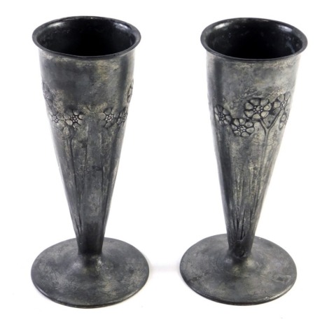 A pair of early 20thC Christopher Dresser design English pewter vases, raised with trees, numbered 0821, marked beneath 16cm high.