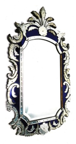 A Venetian wall mirror, the shaped plate with a bevelled edge, the frame with blue mirrored inset and decorated with typical scrolls, shells, etc., 146cm high, 86cm wide. (AF)