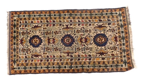 A Persian type rug, with an all over design of medallions, stars, and other geometric devices, on a cream ground, 187cm x 102cm.