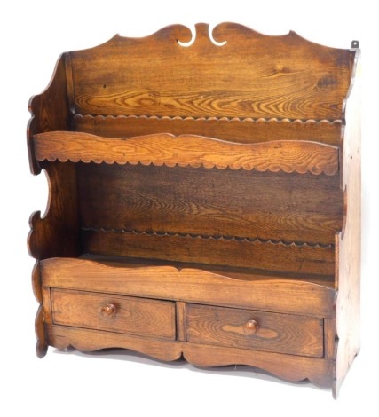 A 19thC elm wall shelf, with a shaped crest, above two shelves each with a gallery, and two frieze drawers, 67cm high, 63cm wide.