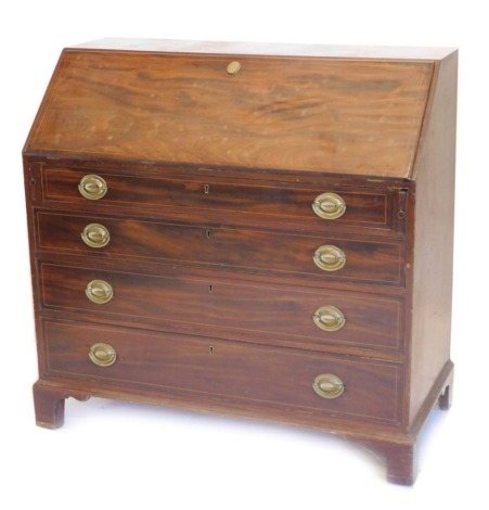 A George III flame mahogany bureau, with fall flap, resting on lopers, having a fitted interior over four graduated drawers with oval brass loop handles, 115cm wide.