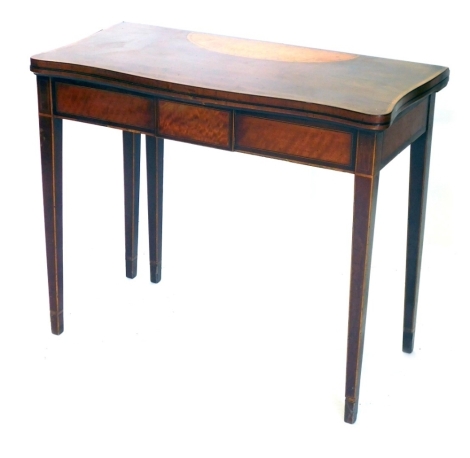 A George III Sheraton serpentine card table, with satinwood cross banding and inlays, with folding top, on square taper legs, 91cm wide.