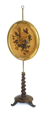 A Victorian simulated rosewood fire pole screen, with brass pole, oval gilt painted velvet floral panel, barley twist and carved base.
