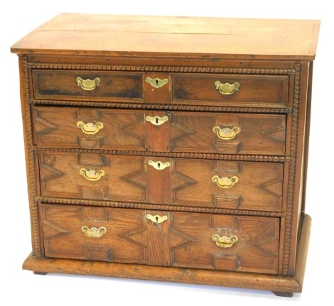 An early 18thC oak chest, of four graduated drawers, with brass solid back plate handles, 84cm high, 95cm wide, 54cm deep.