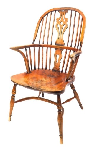 A 19thC ash and elm Windsor armchair, with a pierced splat, spindle turned supports and a solid seat, on turned legs with crinoline stretcher.