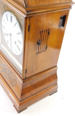 A 19thC walnut cased cuckoo clock, the 18cm diameter Roman numeric dial, in an arched case with a silvered floral inlay, scroll spandrels and bracket feet, with a eight day movement striking on the hour with pendulum and key, 45cm high - 2