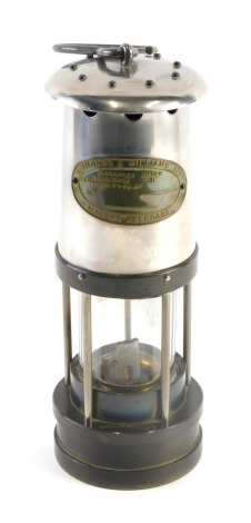 A 20thC E. Thomas and Williams Limited brass and silvered metal miner's lamp, 30cm high.