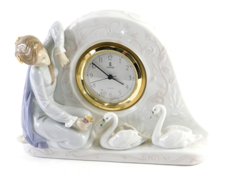 A Lladro girl and swan table clock, numbered 5777, printed and impressed marks beneath, 17cm high.