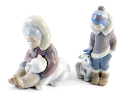 A Lladro pottery figure of a child aside polar bear, number 5238, another child seated aside polar bear, 12cm high. (2)