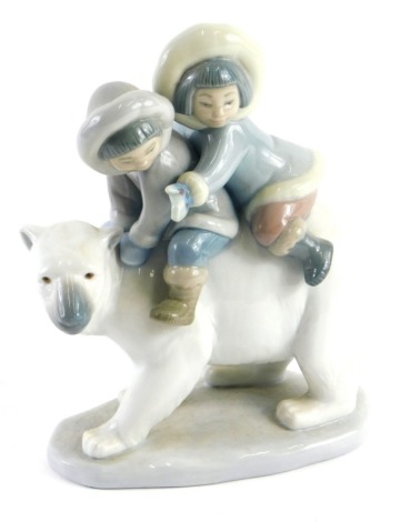 A Lladro porcelain figure, of two Eskimo children riding a polar bear.