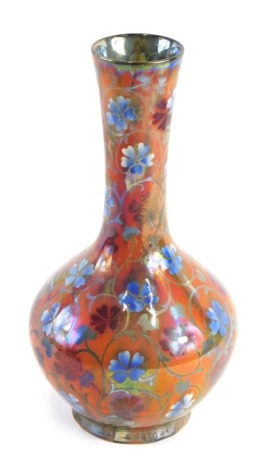 A Pilkington Royal Lancastrian lustre vase, decorated by William S Mycock, with Tudor style flowers, leaves, etc., in blue and red on a mottled ground, monogram mark to underside and dated 1927, indistinct impressed number, 26cm high. (AF)