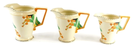 A Burleighware Meadowland graduated set of three jugs, decorated in Art Deco style with flowers and leaves, with angular handle, largest 17cm high.