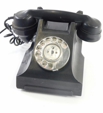 A vintage black Bakelite telephone, with simulated drawer to the front, 24cm wide.