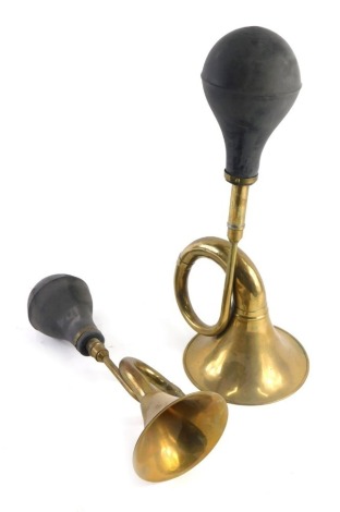 Two replica brass coach horns.