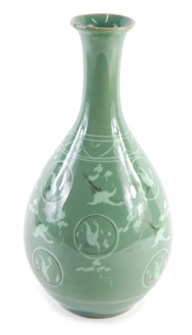 A Japanese celadon glazed porcelain vase, decorated with cranes, etc., printed marks to underside, 32cm high.