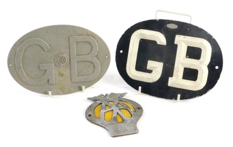 A painted aluminium GB car badge, a cast aluminium AA GB badge, and an AA badge with yellow lettering.